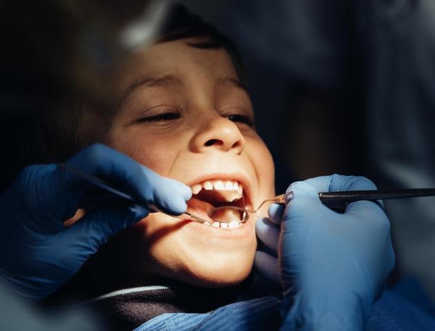 Dentists with a patient during a dental intervention to boy. Dentist  Concept